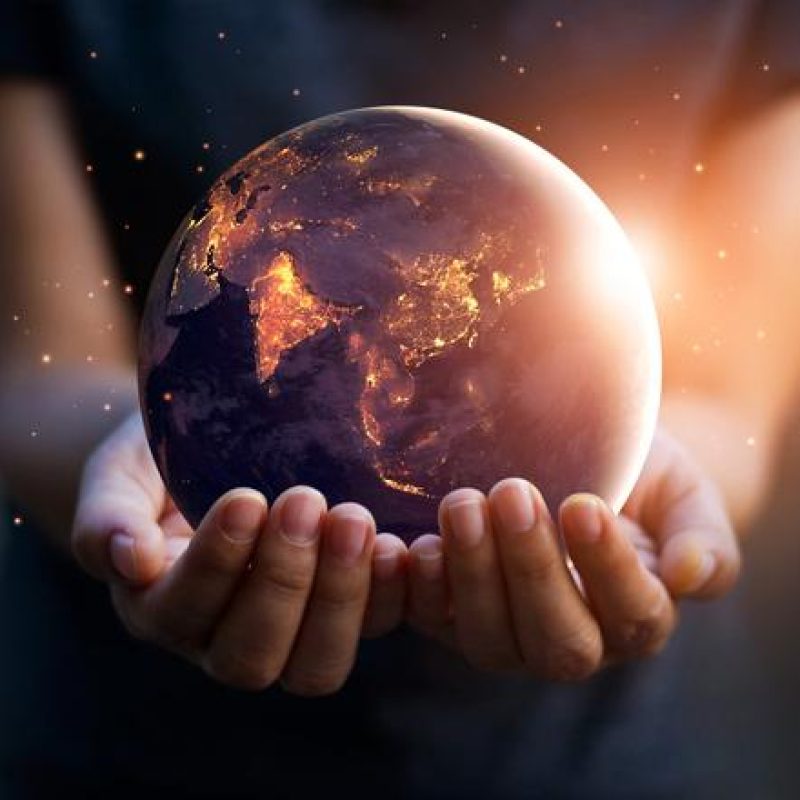 Hands-holding-an-illuminated-globe-of-earth